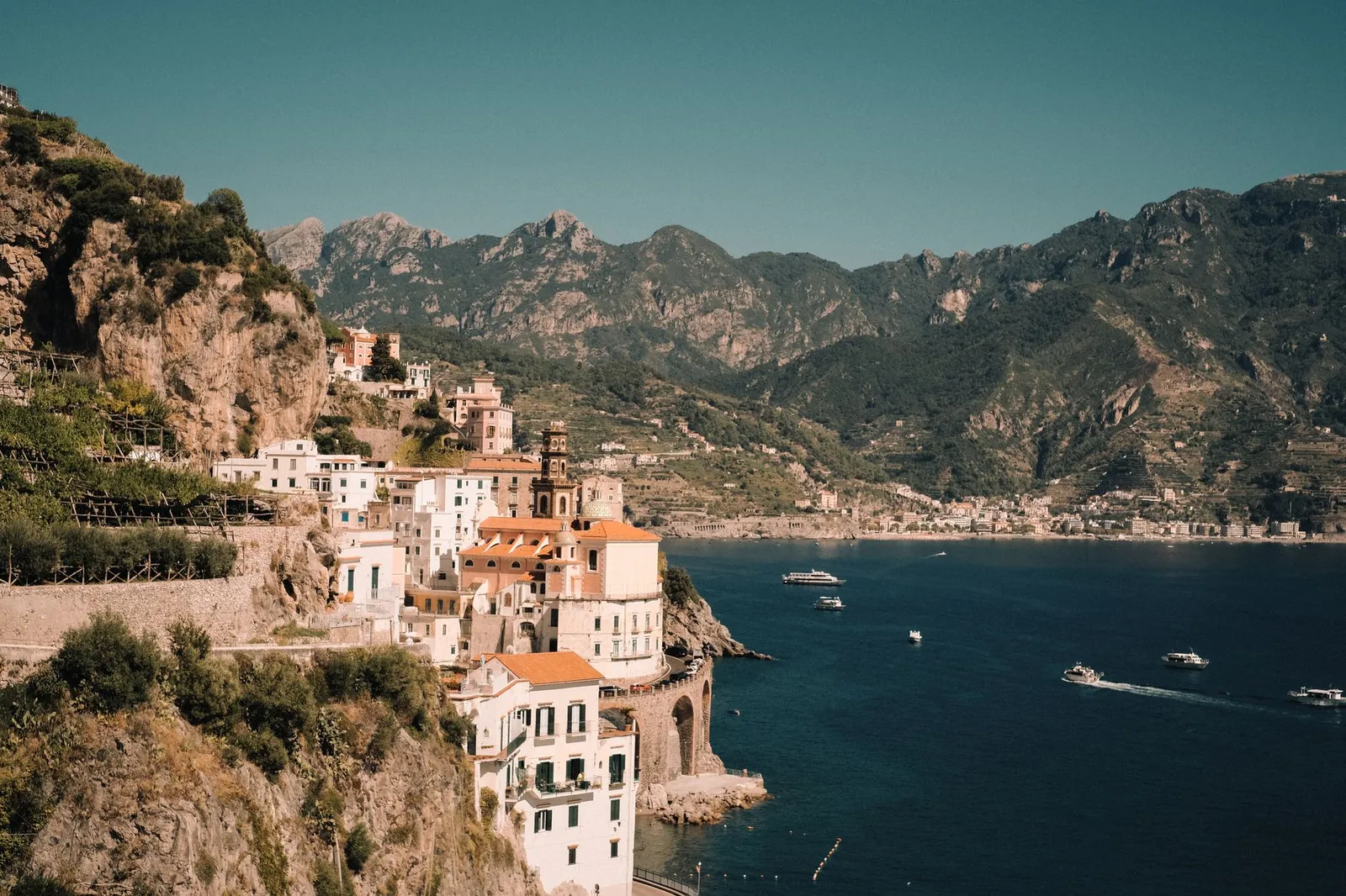 A captivating aerial shot of Atrani on the Amalfi Coast, showcasing historic buildings and azure sea.