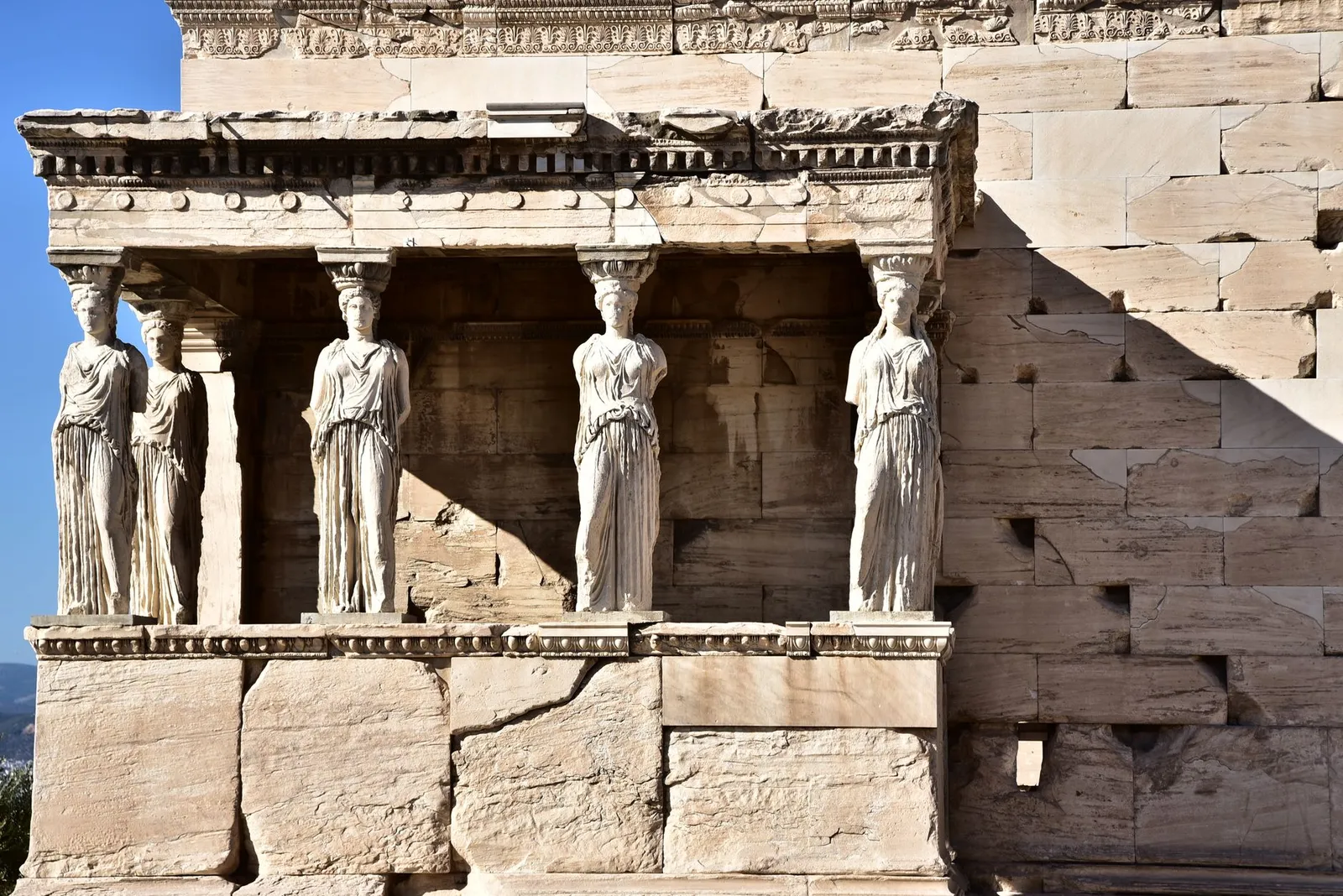 Detailed view of the Caryatids on the Erechtheion at the Acropolis in Athens, Greece. Captures ancient Greek architecture.
