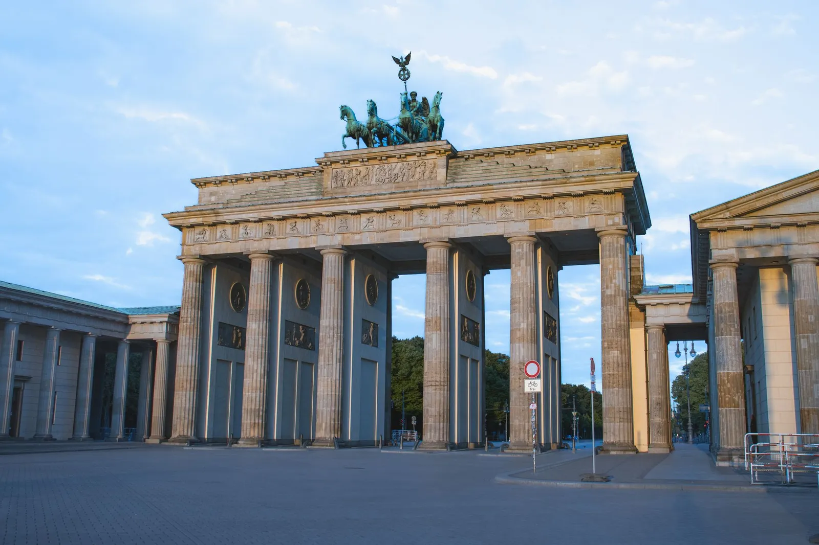 Historic Brandenburg Gate in Berlin, captured on a clear day with vibrant sky.