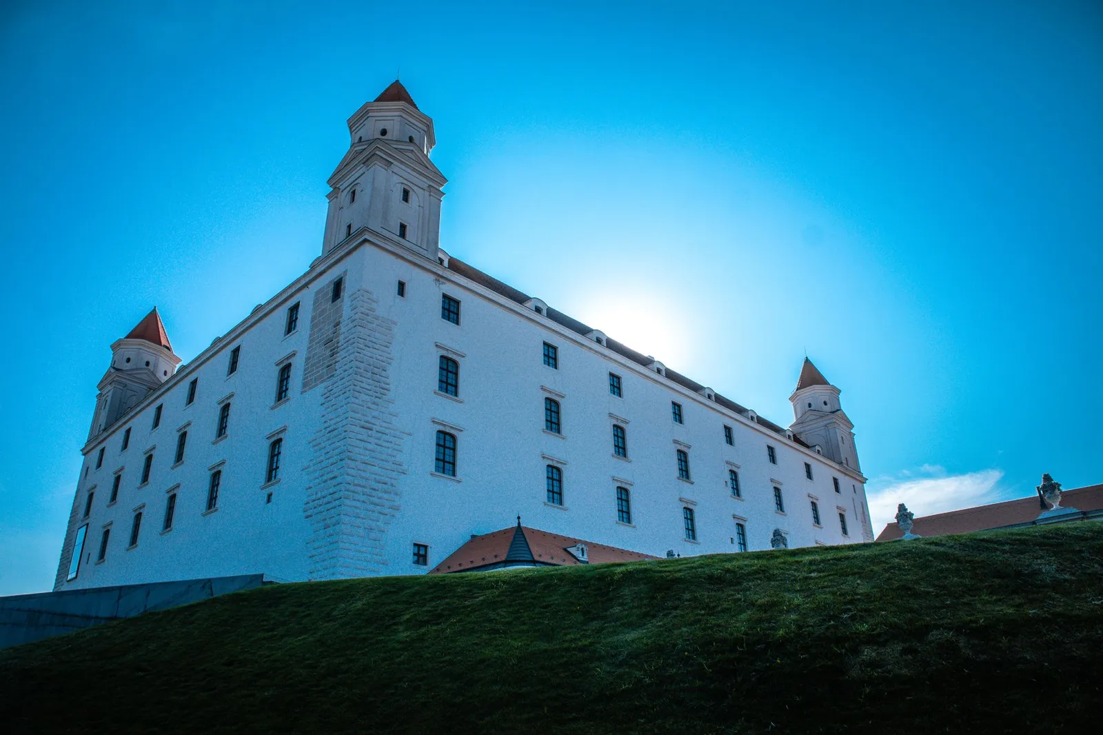 Majestic view of Bratislava Castle against a bright blue sky, showcasing classic European architecture.