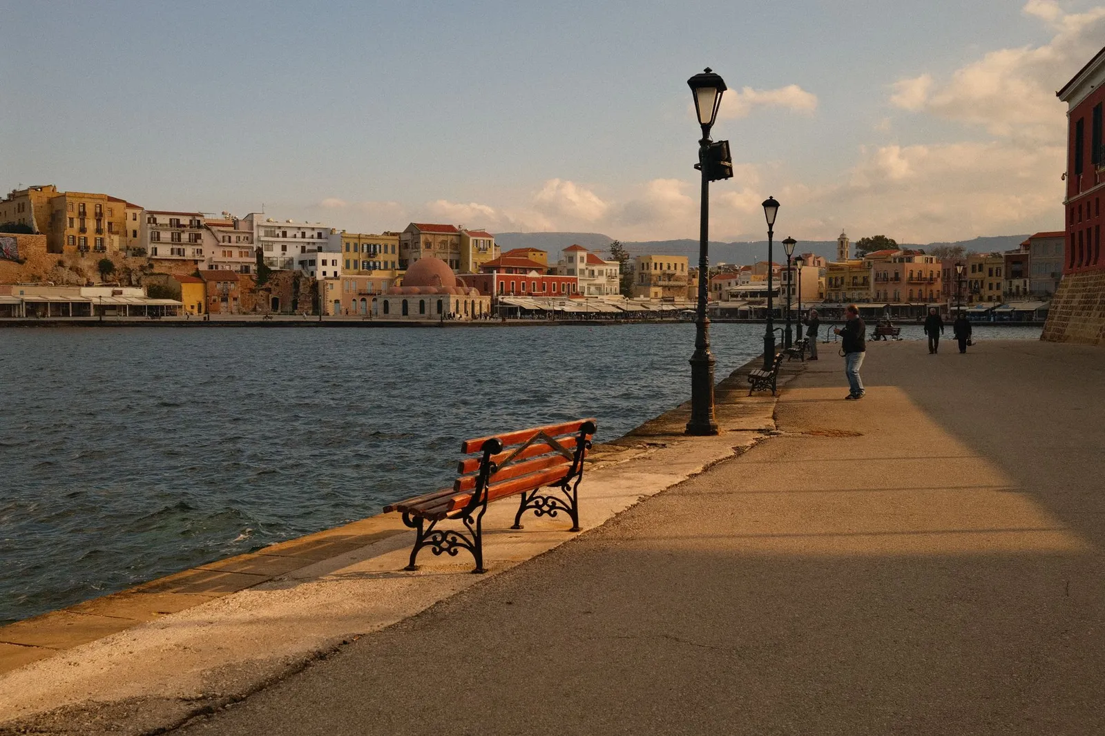 Serene waterfront scene with colorful architecture in Chania, Crete, Greece.