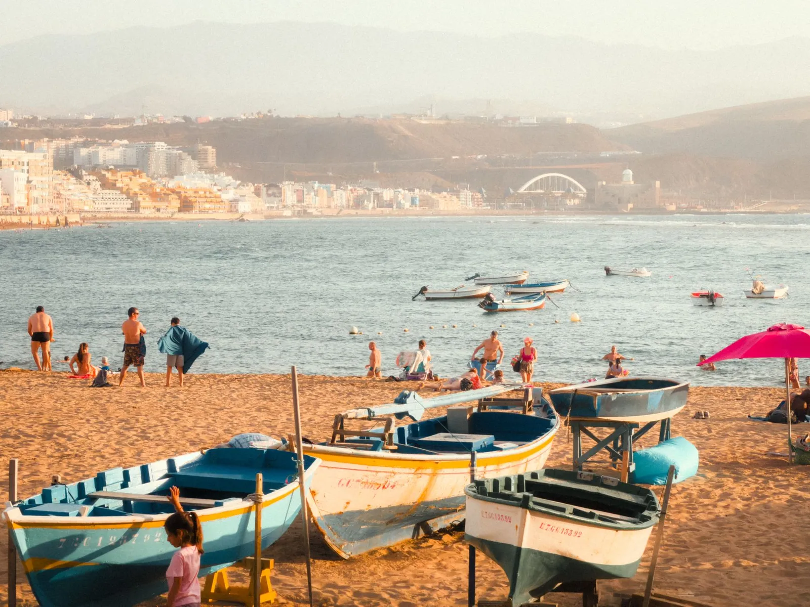 People enjoying a sunny day on Las Canteras Beach in Las Palmas de Gran Canaria, Spain.
