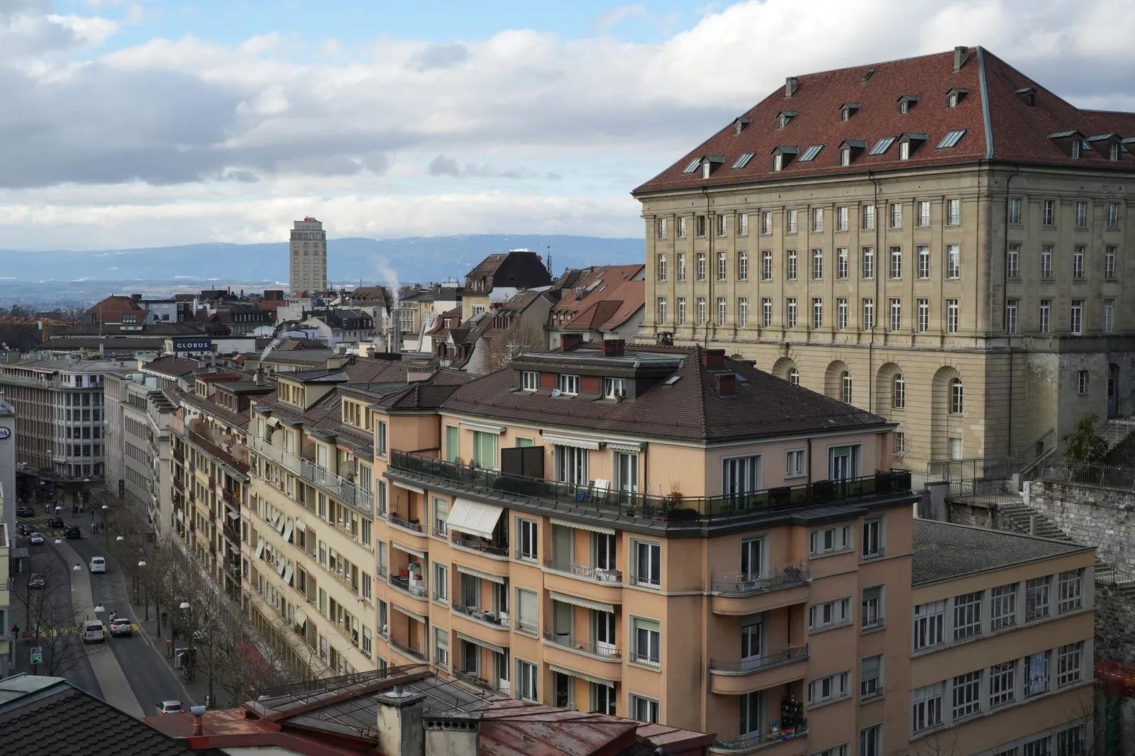Panoramic view of Lausanne's historic architecture with rooftops and a clear sky.