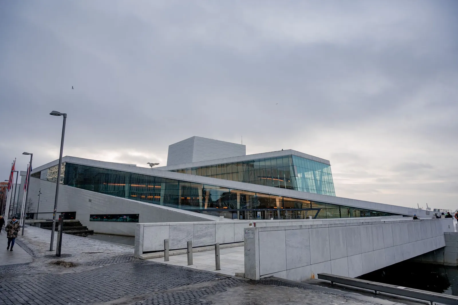 Captivating winter scene of Oslo Opera House showing modern architecture and serene urban surroundings.