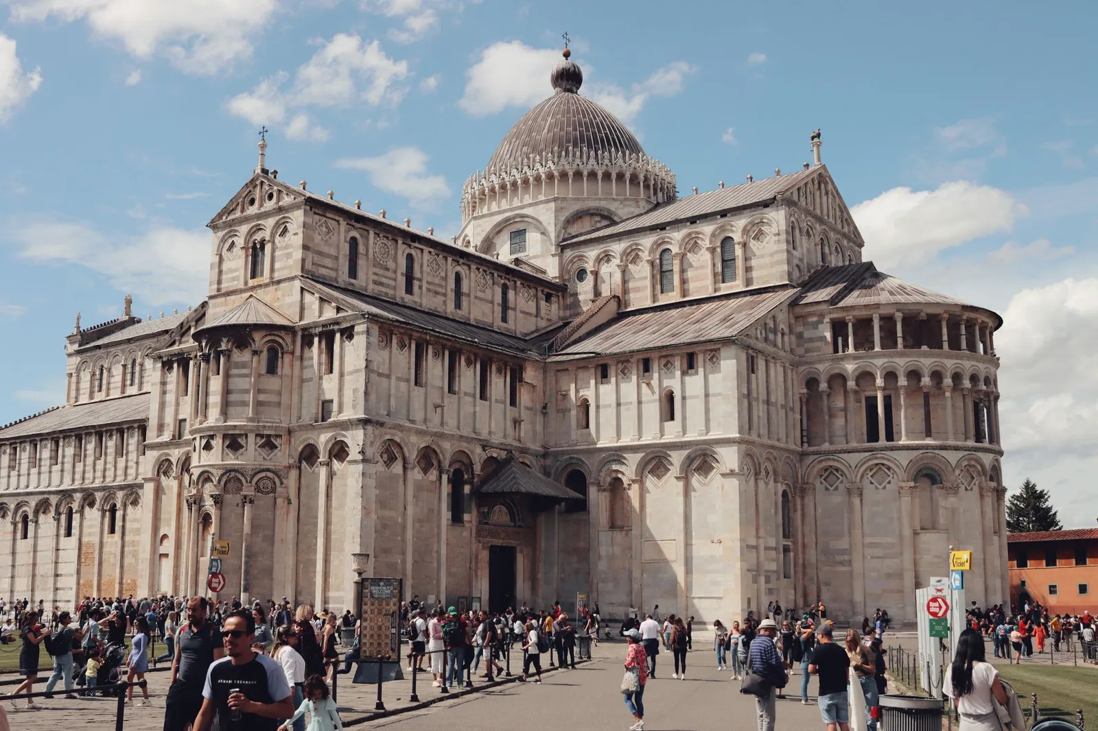 A bustling scene of Pisa Cathedral in Piazza dei Miracoli, a UNESCO World Heritage Site in Italy.
