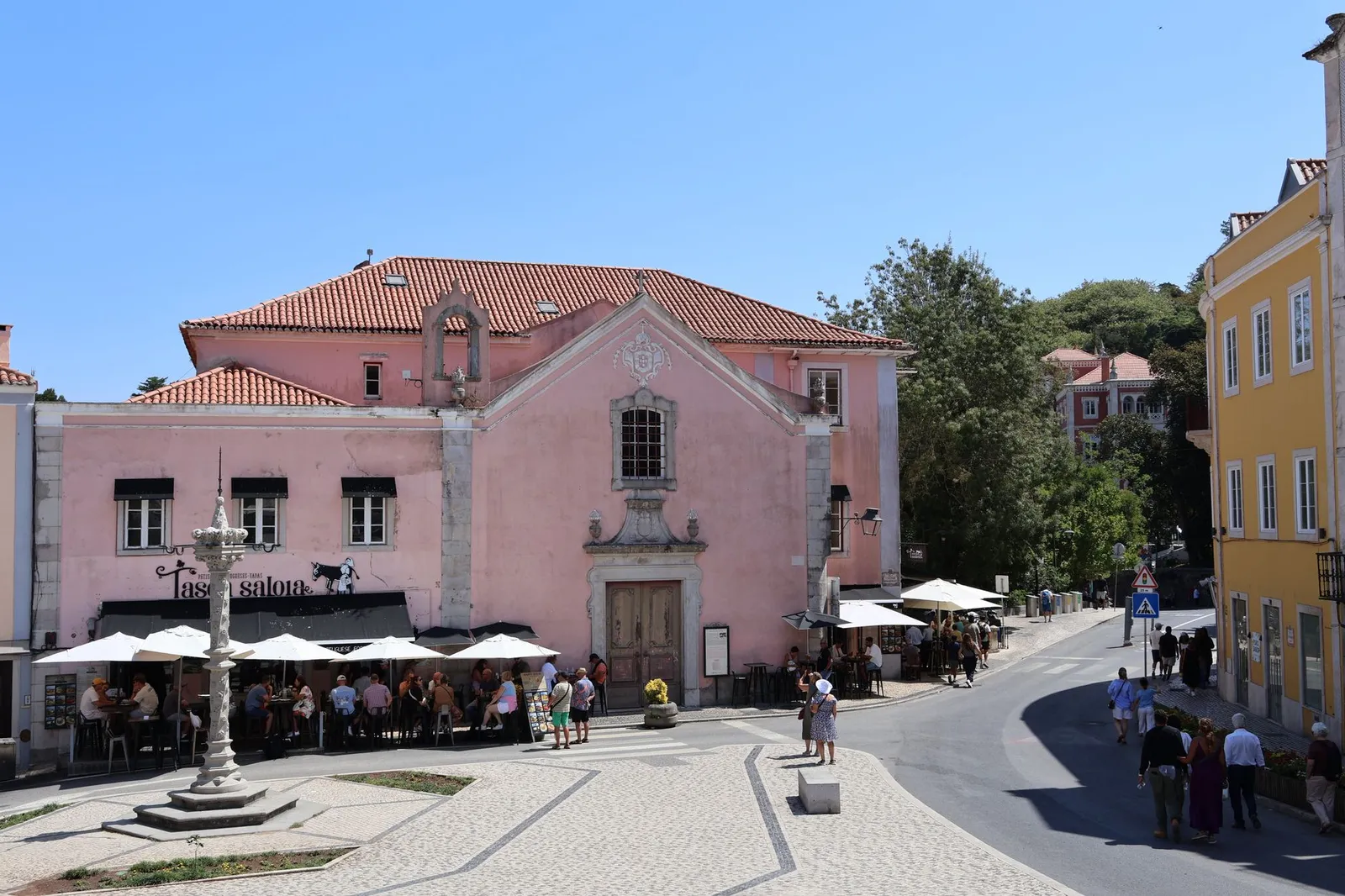 Vibrant street scene in Sintra, Portugal with colorful architecture and lively cafes.