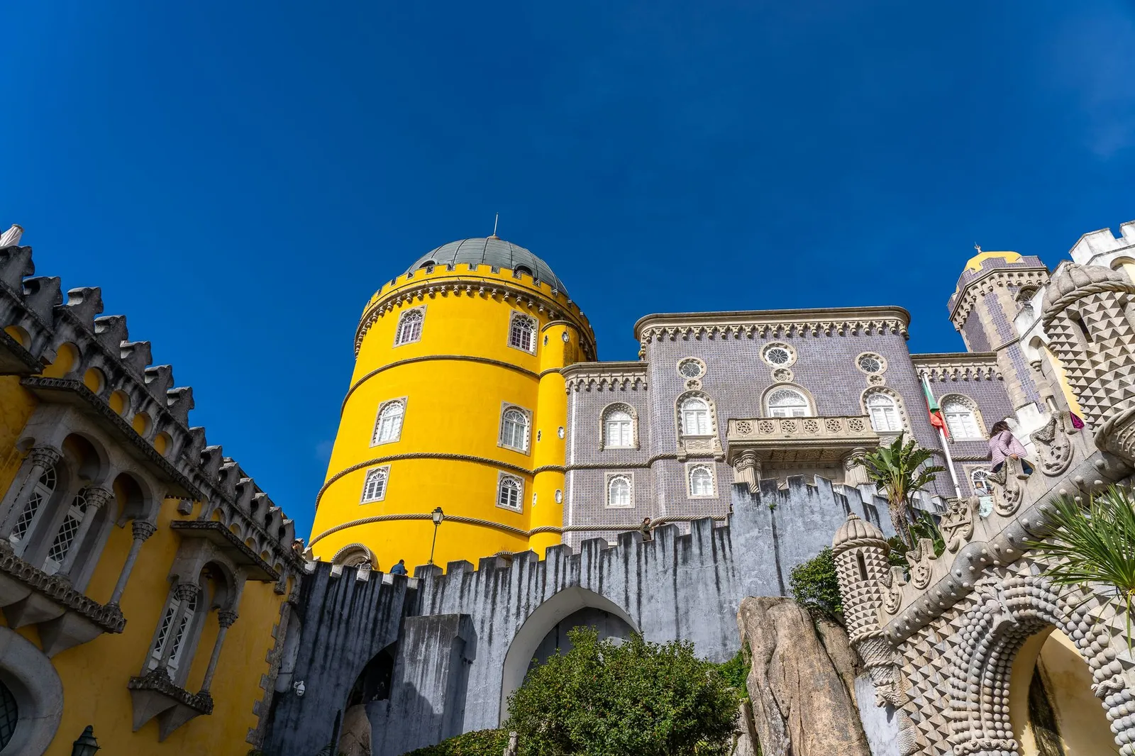 Photo of the vibrant towers and intricate design of Pena Palace in Sintra, Portugal.