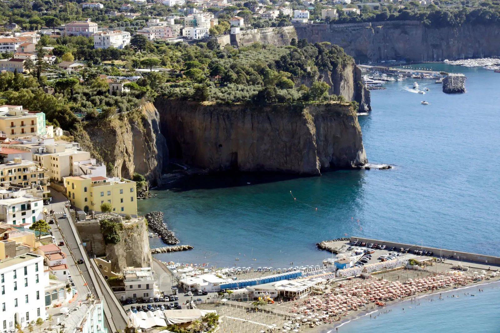 Stunning aerial shot of Sorrento's cliffs and beach in Naples, Italy, with vibrant sea views.