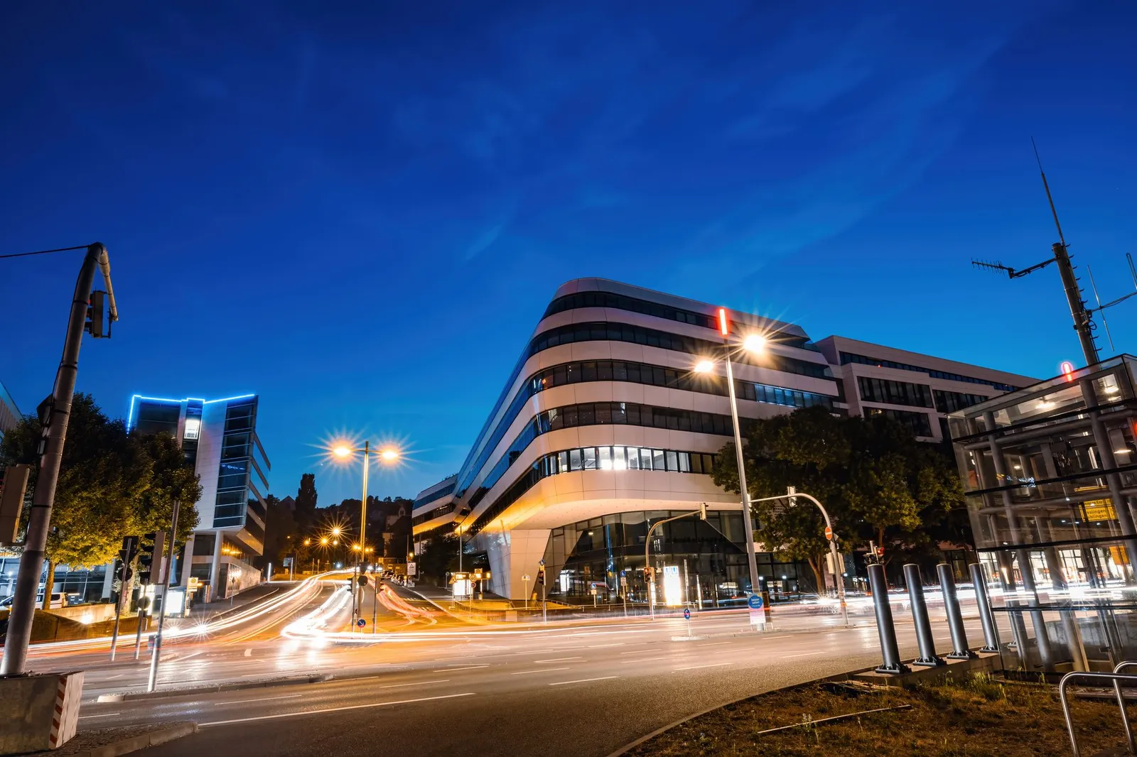 Stunning view of modern buildings in Stuttgart captured during twilight with light trails.