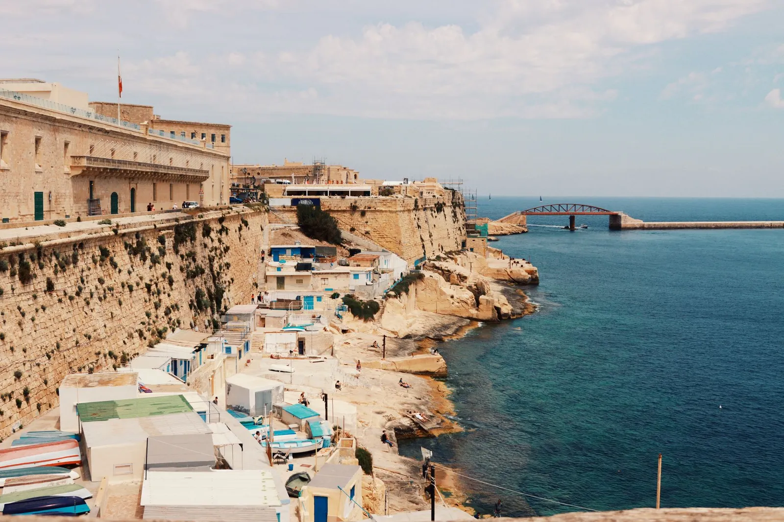 Explore the stunning cliffside and azure waters of Valletta, Malta, showcasing its rich urban landscape.