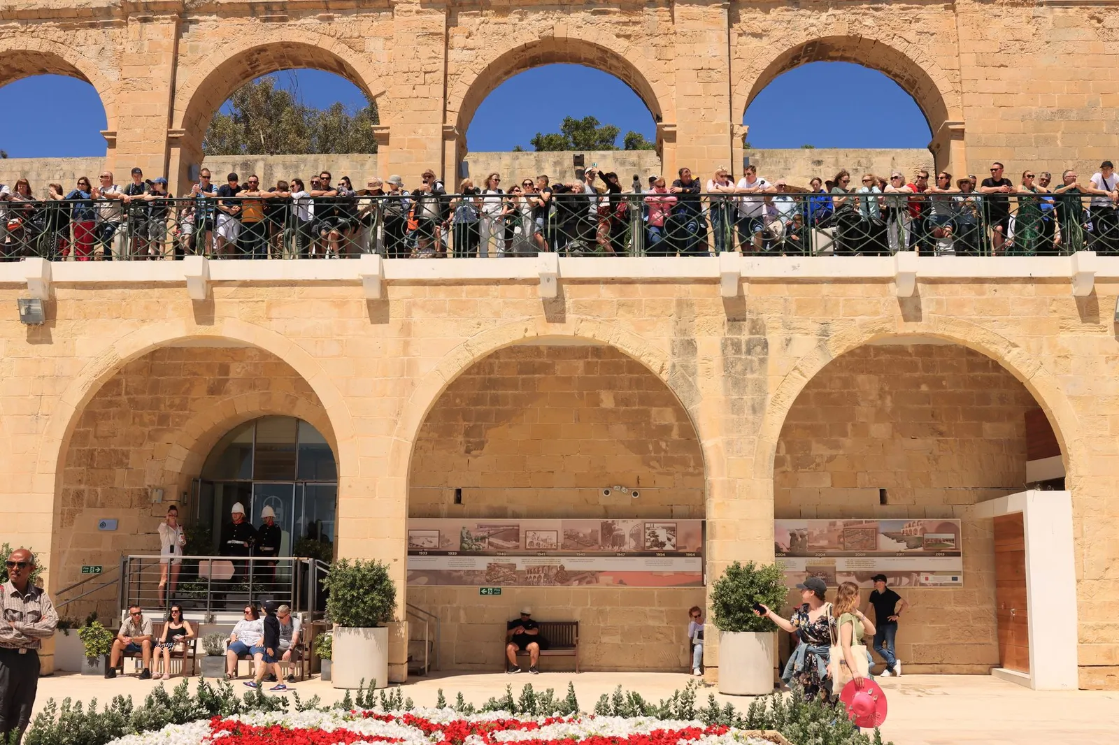 Crowds admire views from Upper Barrakka Gardens in Valletta, Malta.